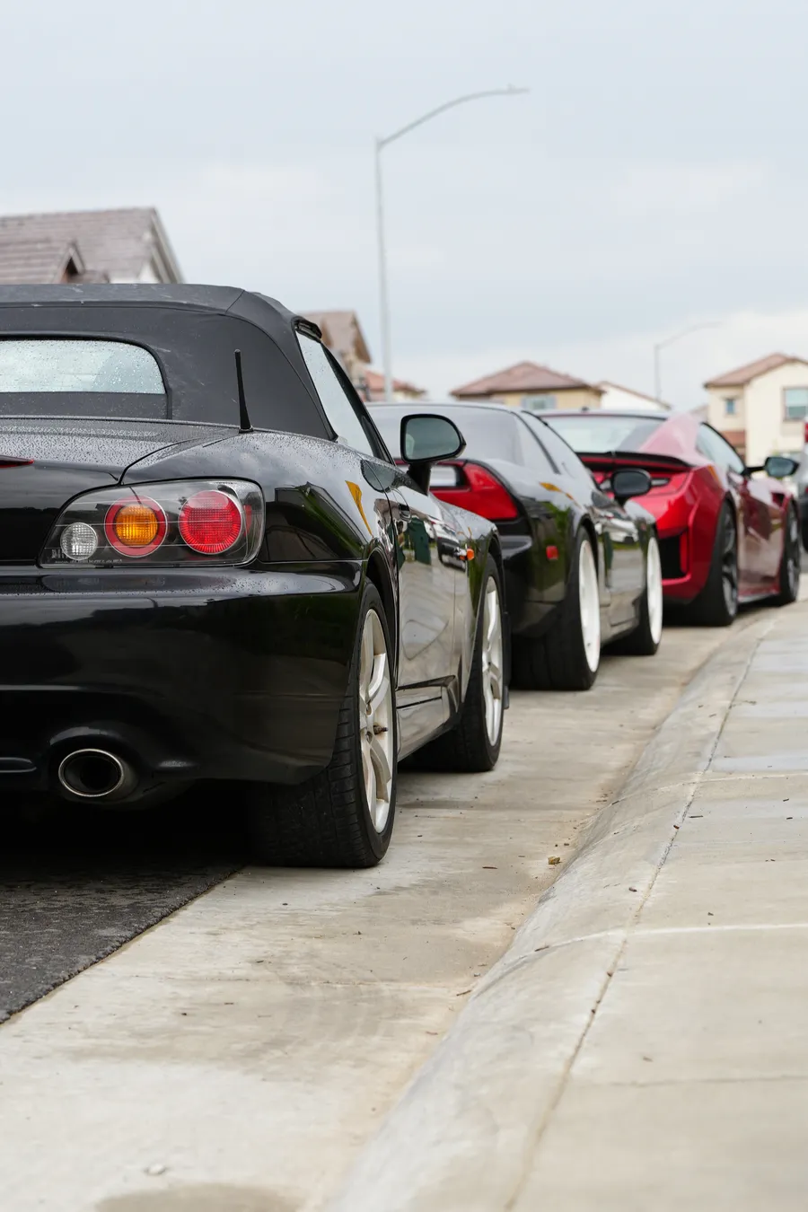 Black 2006 Honda S2000 side profile, soft top up